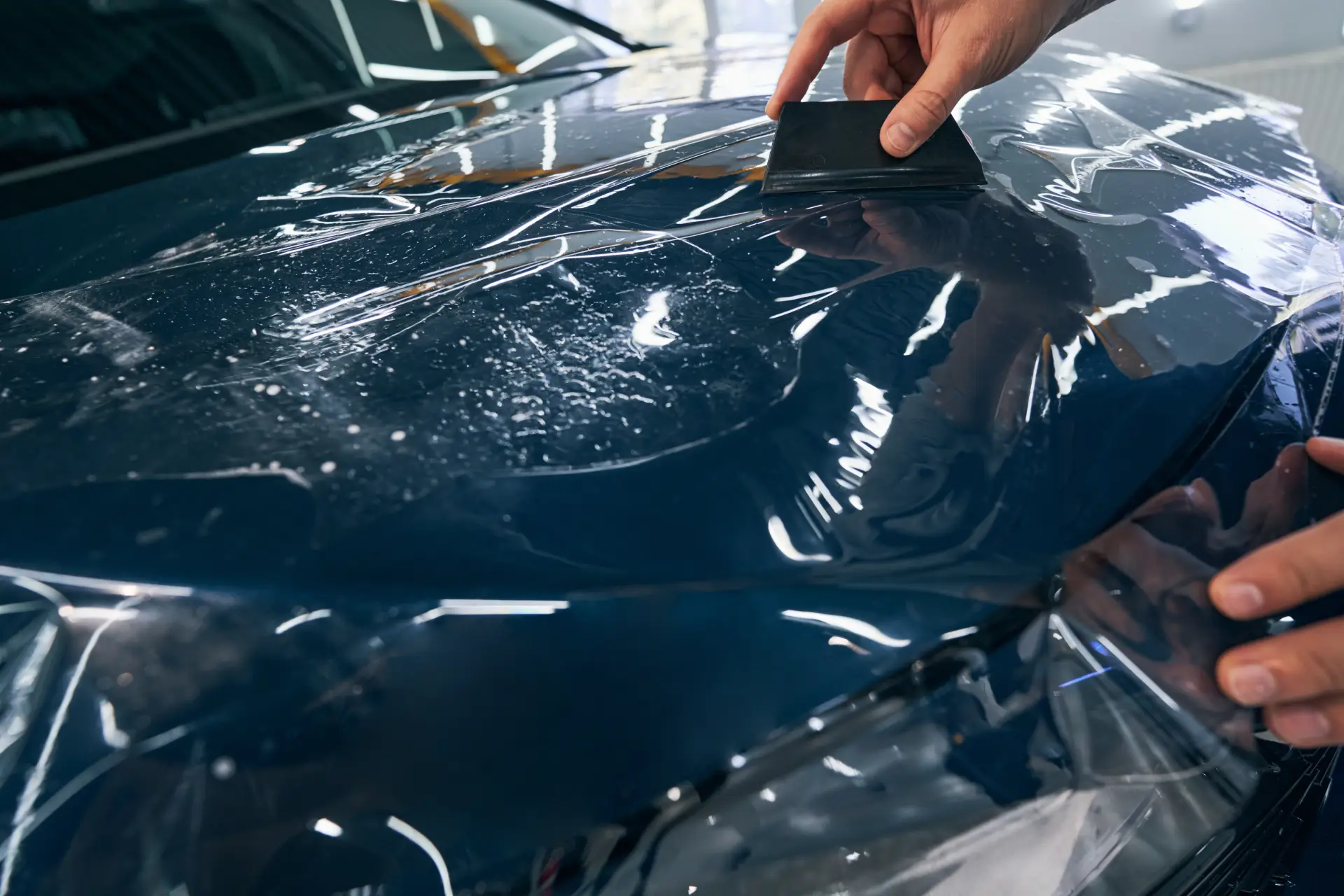 auto-service-technician-installs-protective-film-w-2024-10-22-03-23-03-utc